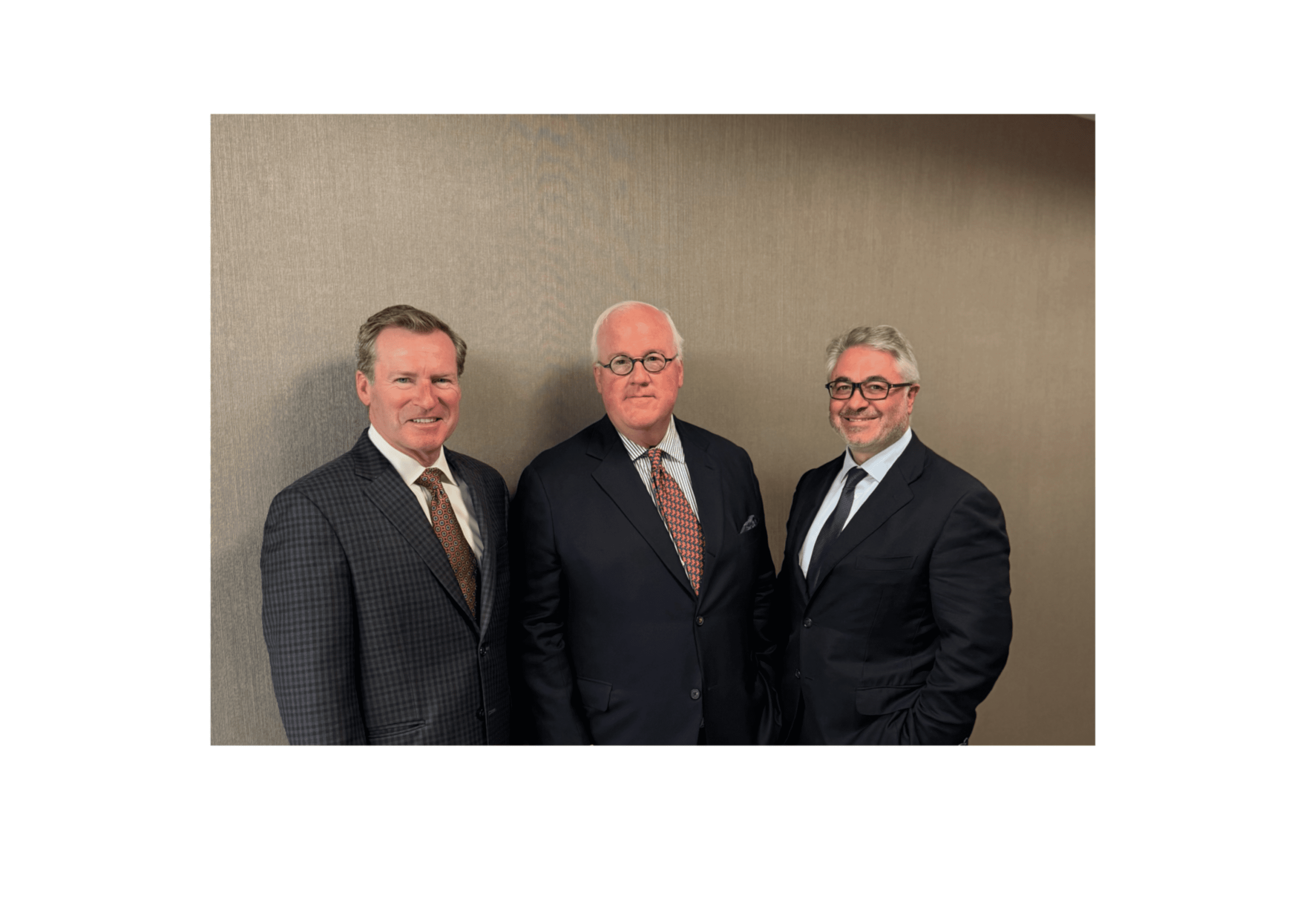 Three men in suits and ties standing next to each other.